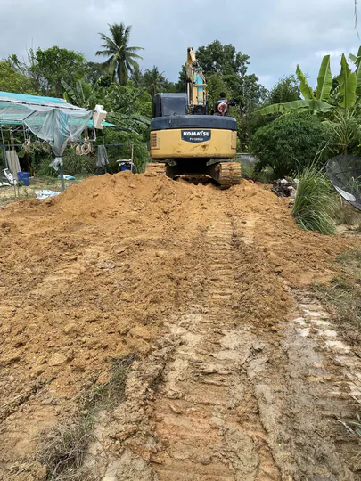 Building an access road to the site: base layers, slopes and drainage