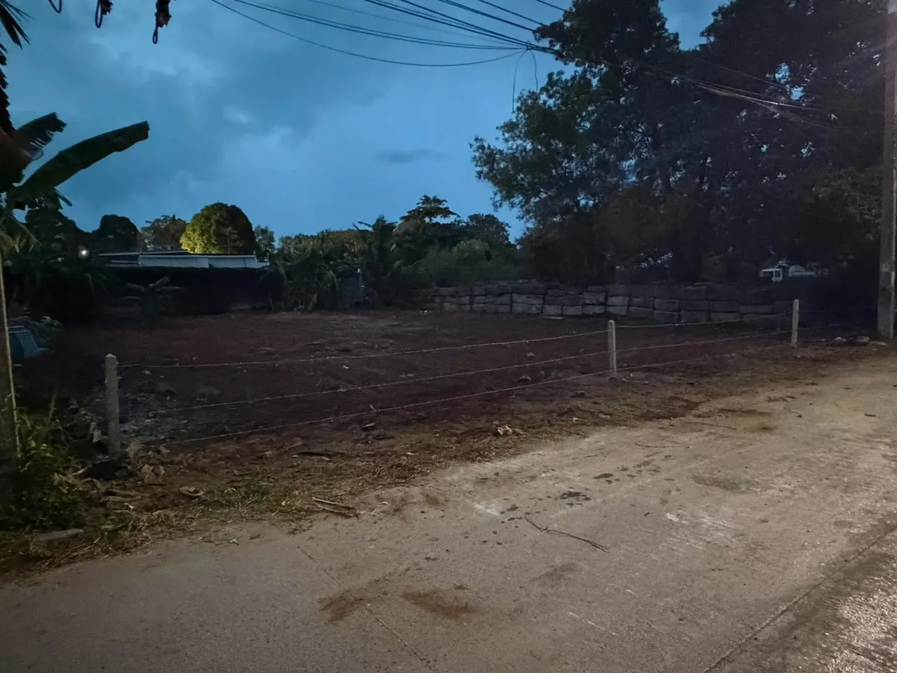 The same plot after clearing, fill and leveling - with a new fence line