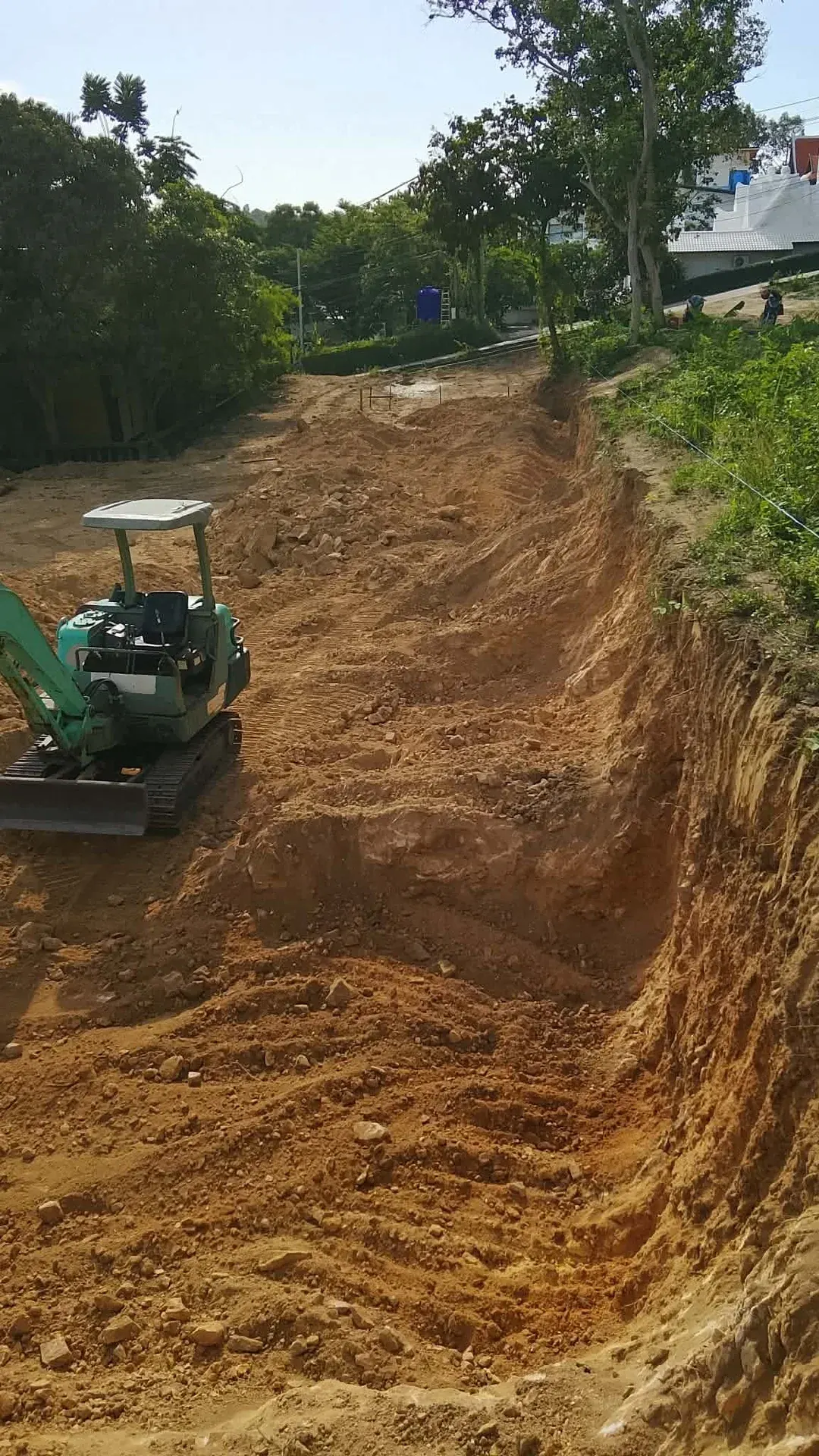 Soil excavation and the cut slope formed along the plot boundary