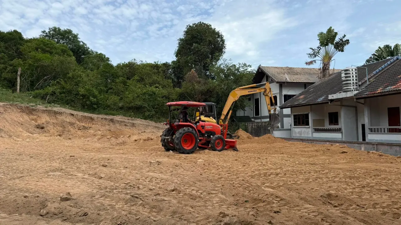 Excavator and tractor working as a pair