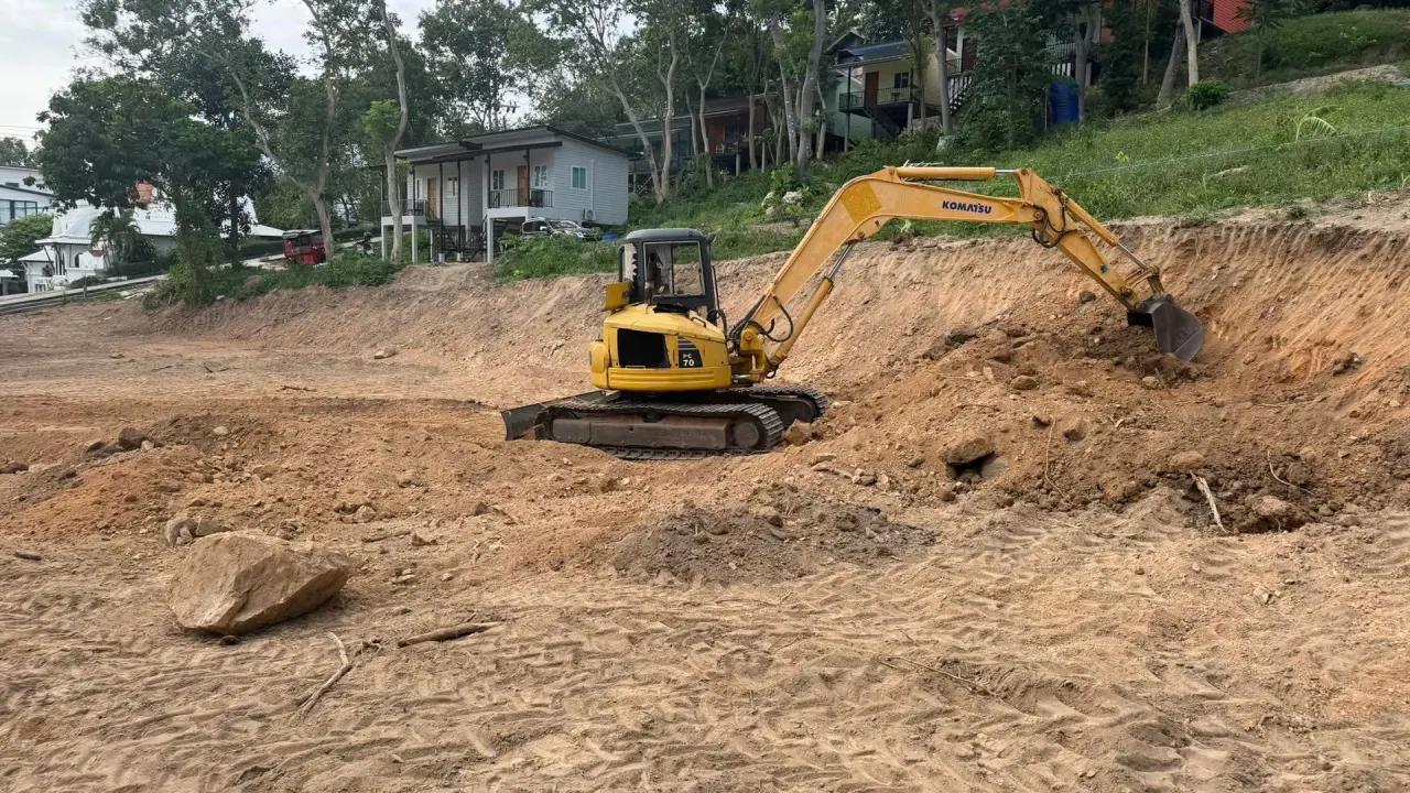 Yanmar ViO70 excavator cutting soil on the plot