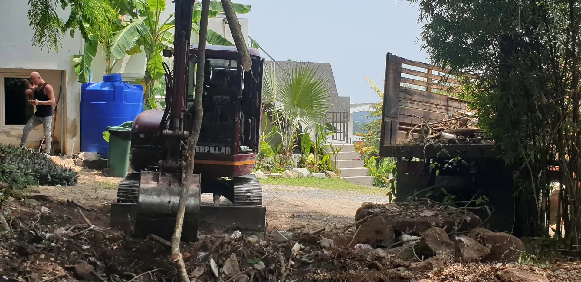 Loading cleared vegetation and debris into the truck for removal