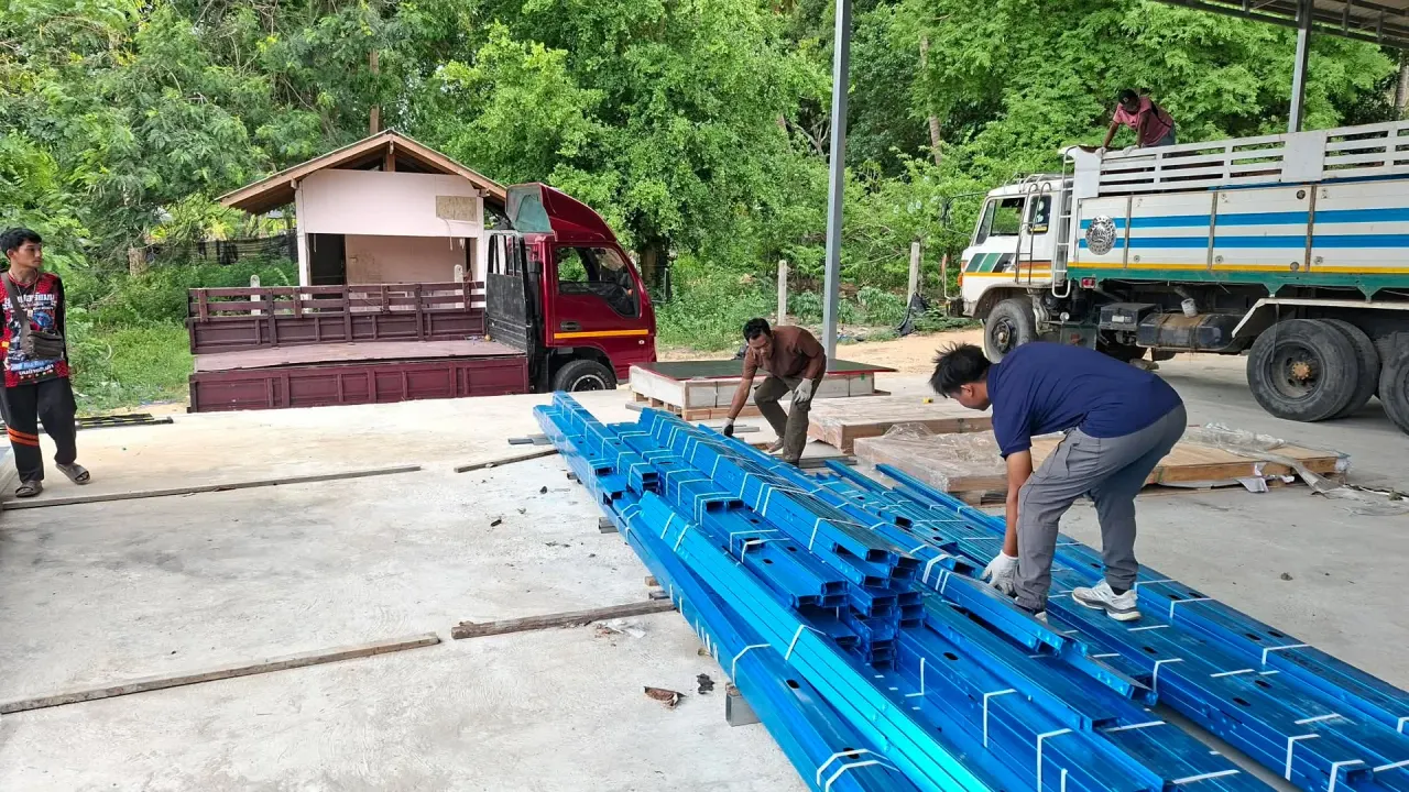 Loading steel purlins and beams onto the truck at the supplier's yard