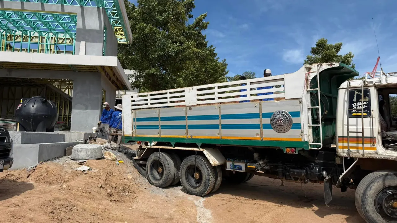 Unloading steel frame sections at the site in Chong Mon