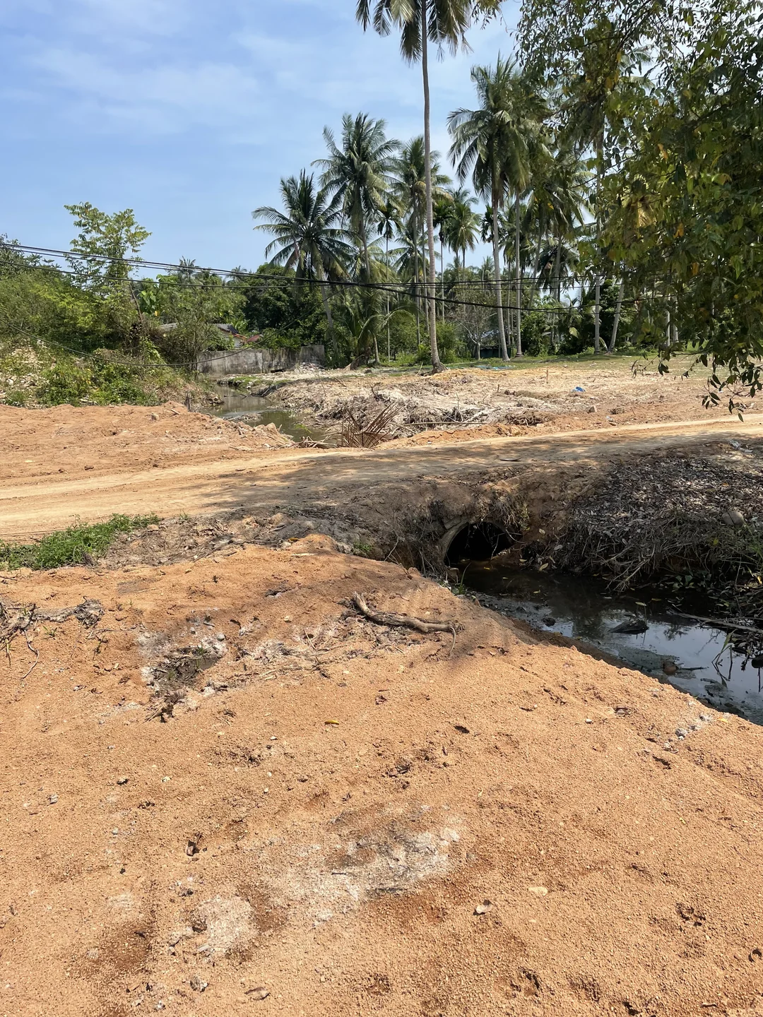 Drainage pipe installed under the road to allow water to exit the plot