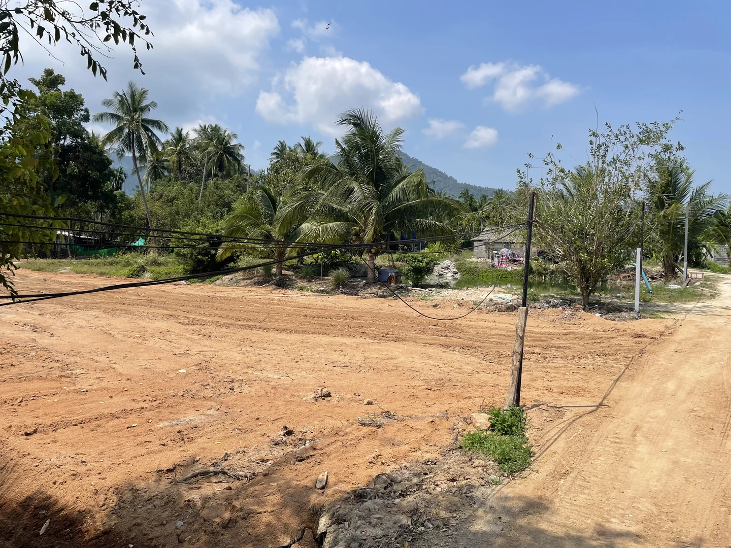 Drainage, backfill and leveling on a waterlogged plot in Maenam