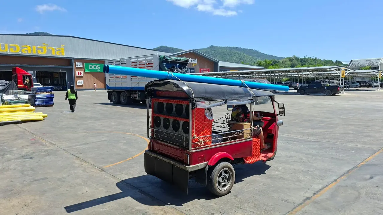 Delivering PVC pipes from the builders' market on our tuk-tuk