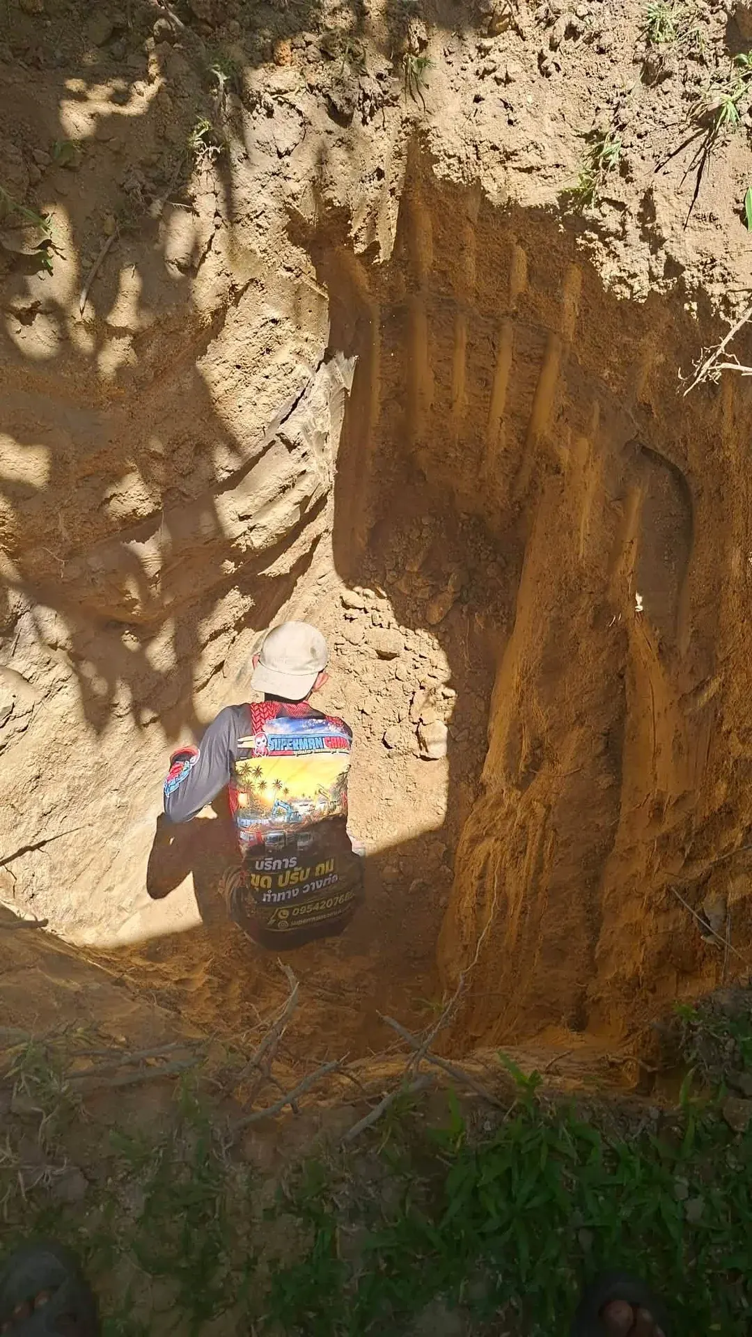 Digging the pit for the septic rings in the tight space of the garden