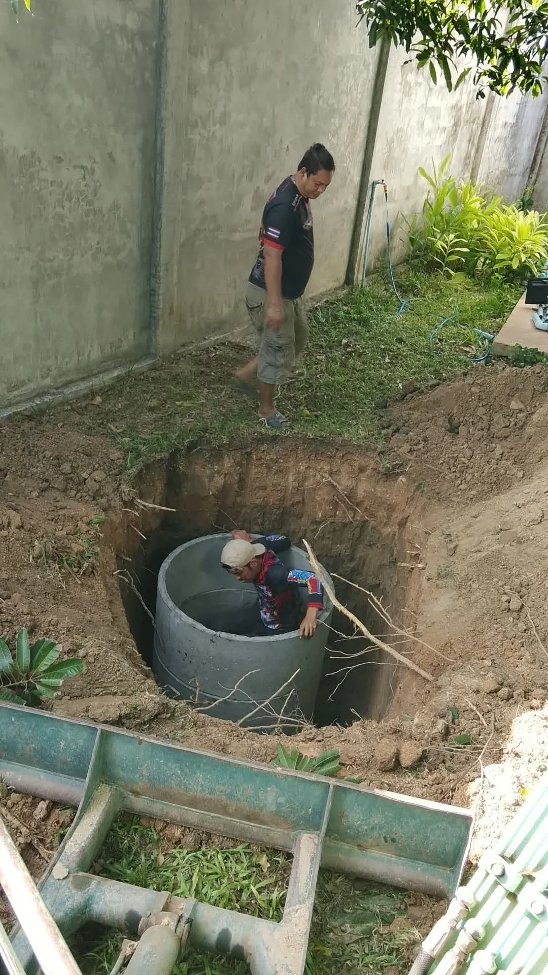 Lowering a concrete ring into the prepared pit