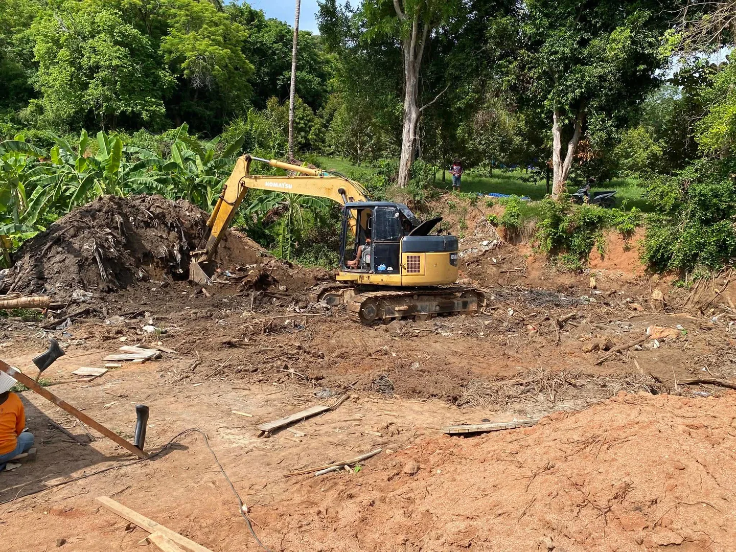 Clearing a large pile of construction debris and waste from the site