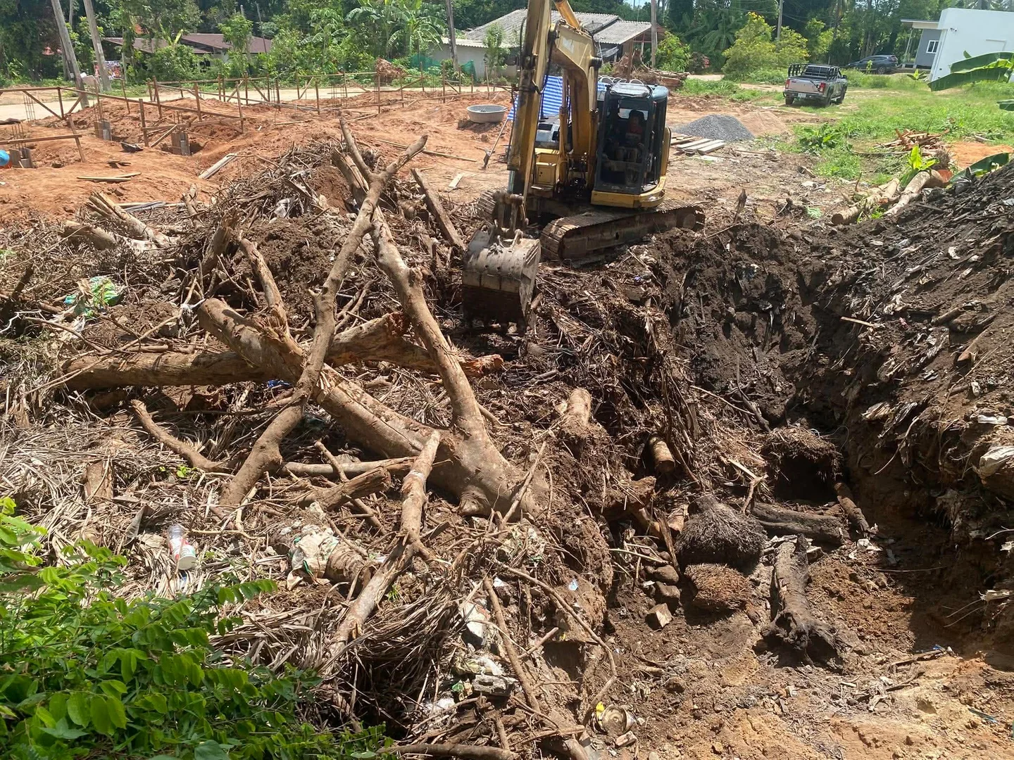 Komatsu PC128 excavating deep root systems from the plot