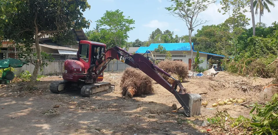 Removing tree roots and clearing land for construction