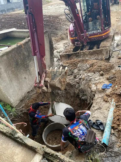 Installing sewer lines and digging trenches for utilities