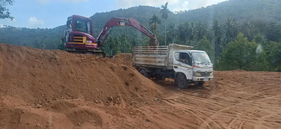 Truck delivery of soil, dirt, and other bulk materials to construction site